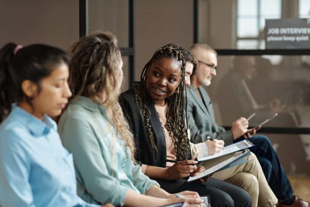 Group of candidates sitting in queue for job interview